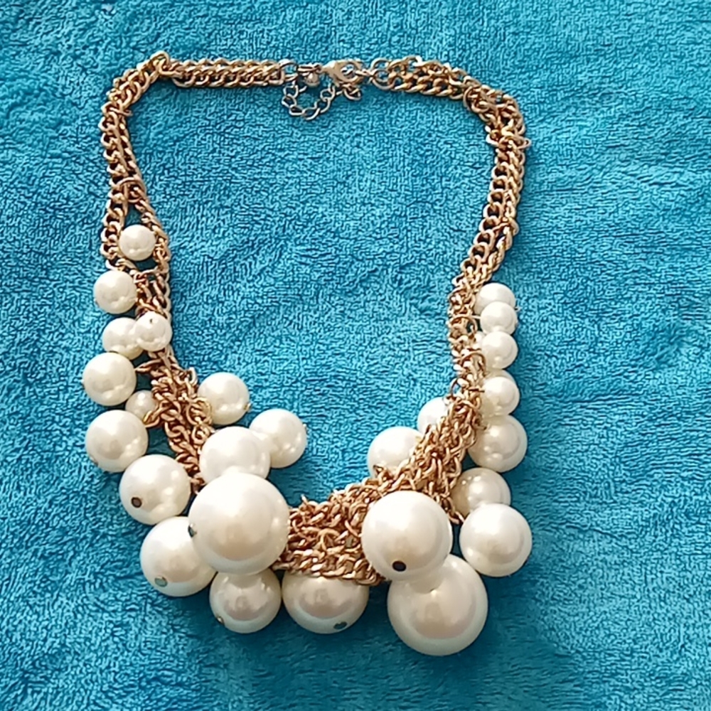 Gold toned short necklace with pearl colored balls